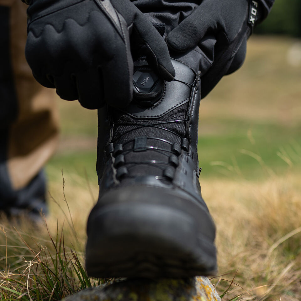Person using a boa dial to adjust a fox adventure boot