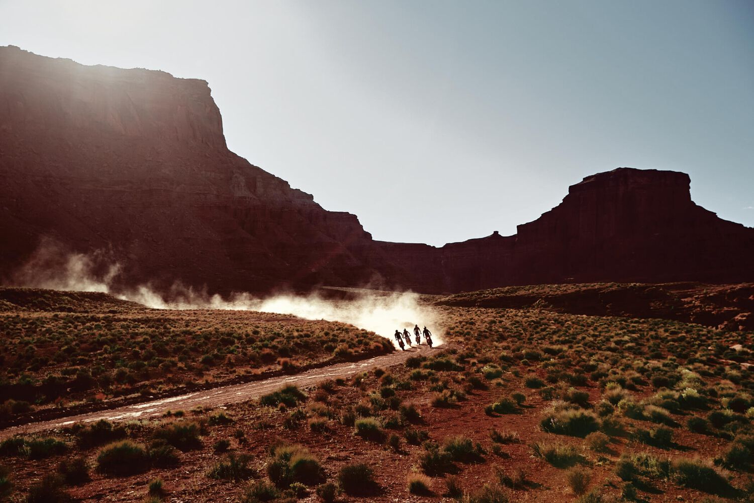 A group of enduro rider riding in the distance.