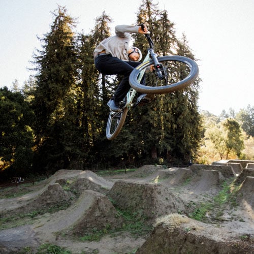Eddie Reynolds jumping his bike in a bike park.