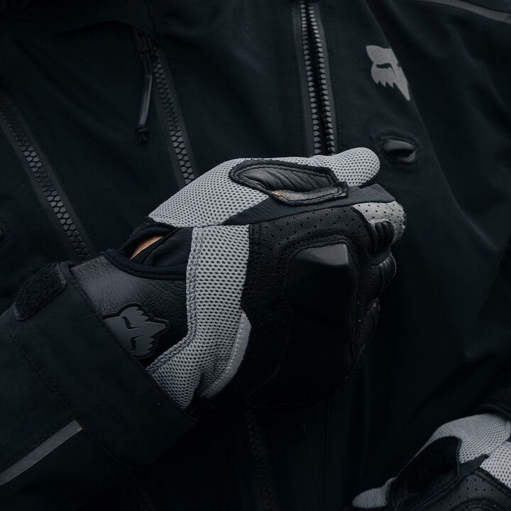 gloved hand zipping up an adv jacket