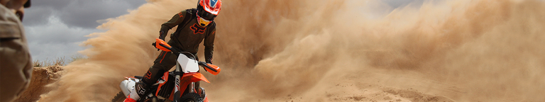 Dirt bikers ripping through the wet terrain with Fox Legion Offroad